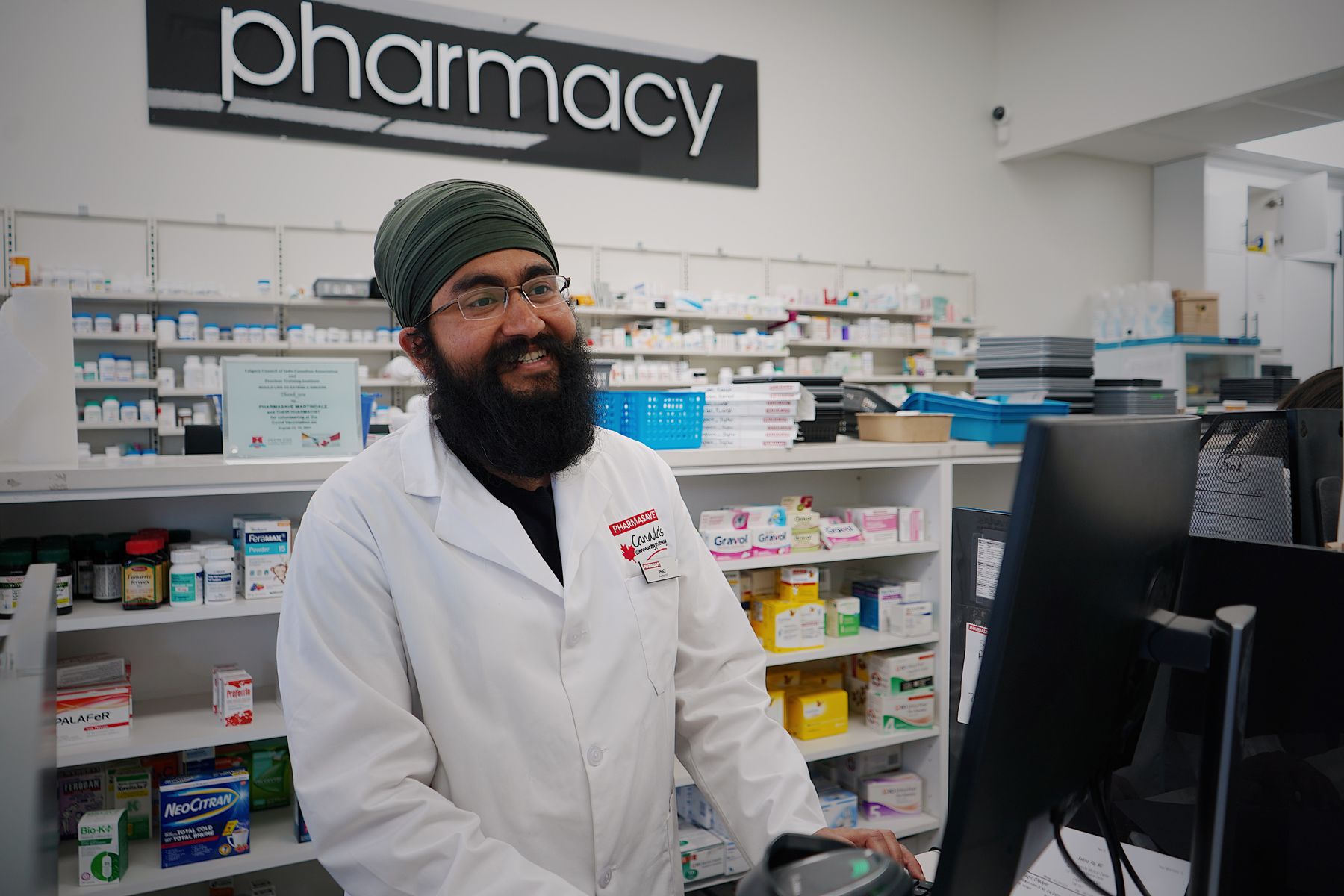 Smiling pharmacist at a pharmacy counter
